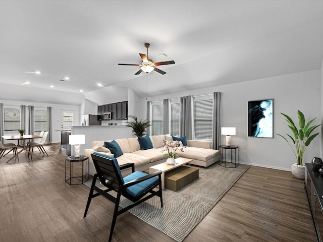 living room with ceiling fan, dark hardwood / wood-style floors, and lofted ceiling