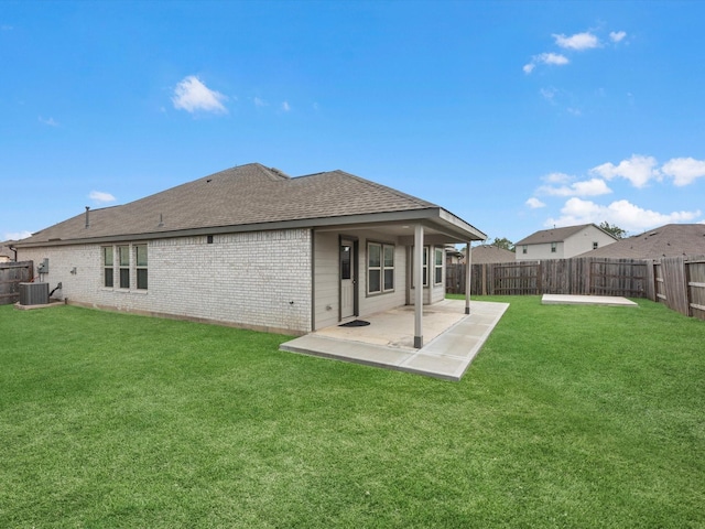 back of house with a yard and a patio area