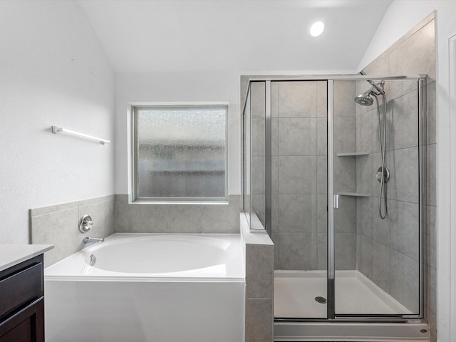 bathroom with plus walk in shower, vanity, and lofted ceiling