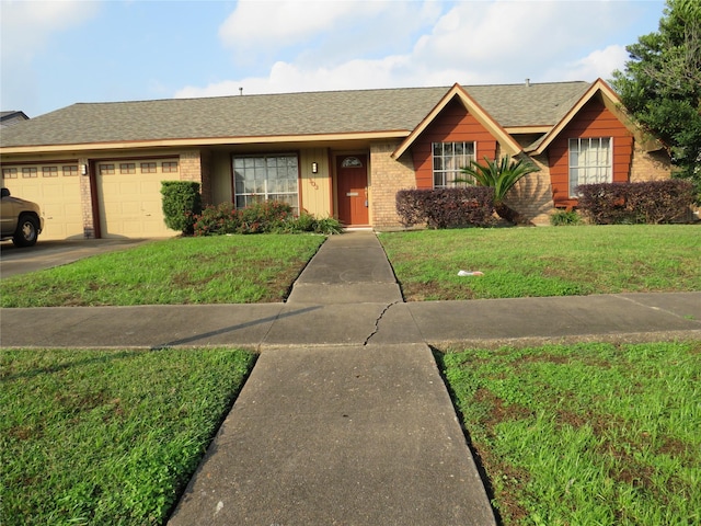 single story home featuring a front lawn and a garage