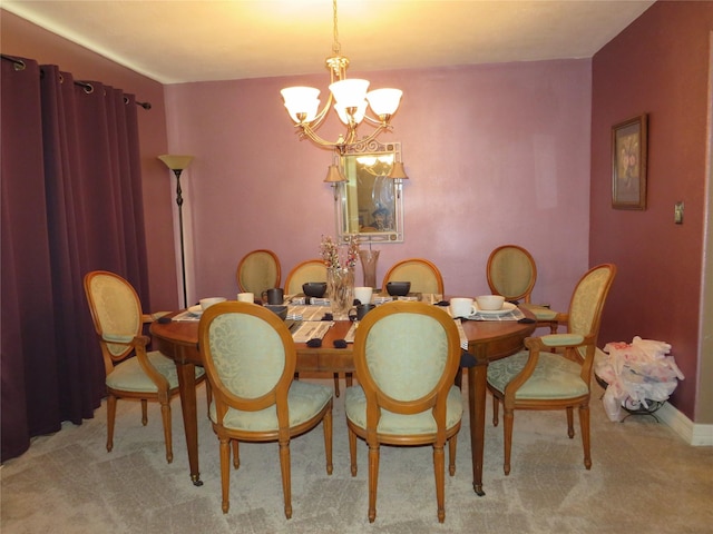 carpeted dining room featuring a notable chandelier