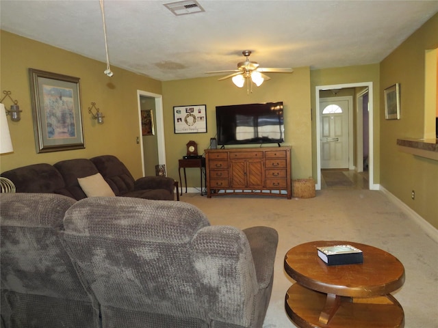 carpeted living room featuring ceiling fan