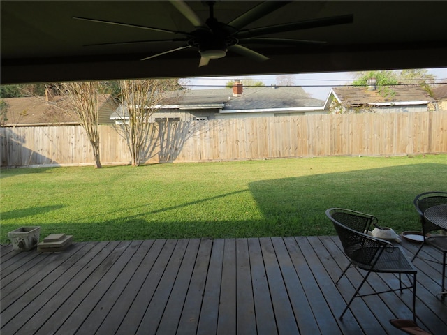 view of yard with a wooden deck and ceiling fan