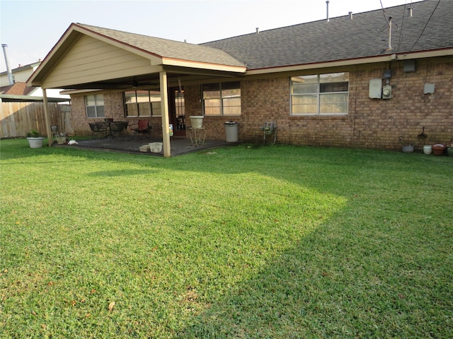 back of property with a patio and a lawn