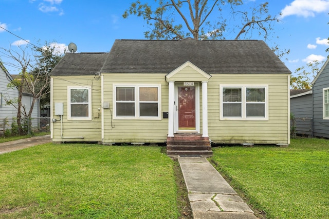 bungalow-style home featuring a front yard