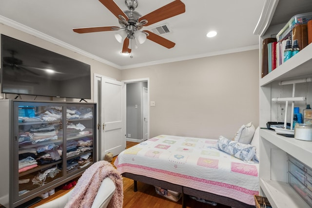 bedroom featuring wood-type flooring, ceiling fan, and ornamental molding