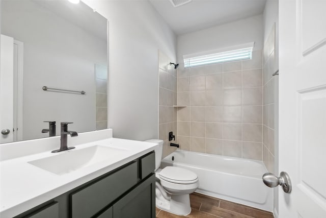 full bathroom with vanity, toilet, and tiled shower / bath