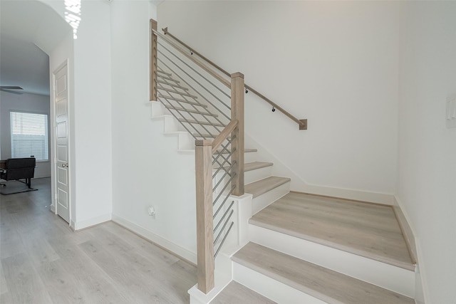 stairway with hardwood / wood-style flooring