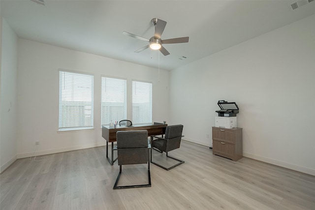 office area with light wood-type flooring and ceiling fan