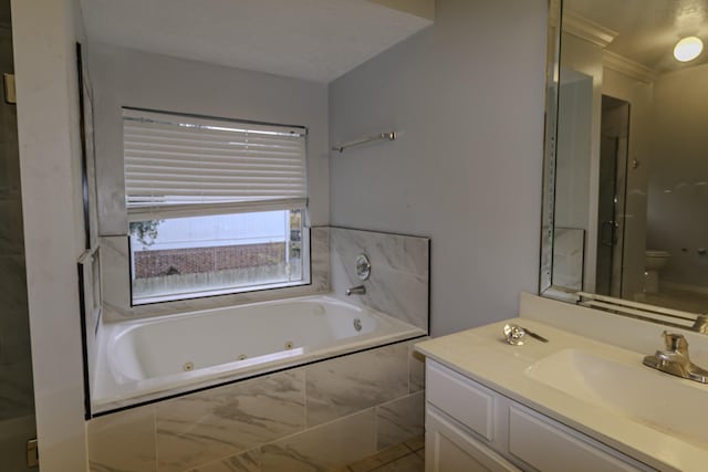 full bathroom featuring shower with separate bathtub, vanity, and toilet