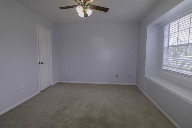 empty room featuring carpet flooring and ceiling fan