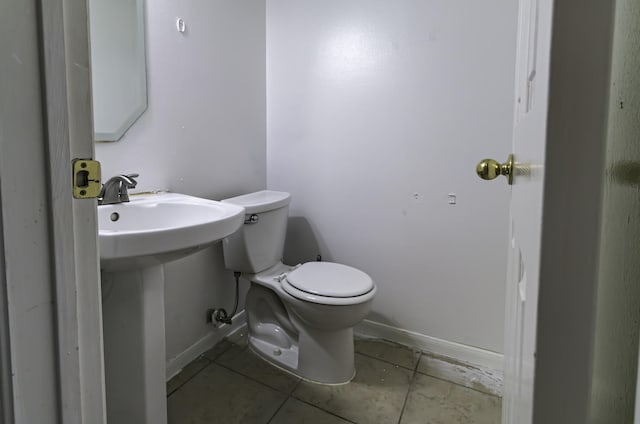 bathroom with tile patterned flooring and toilet