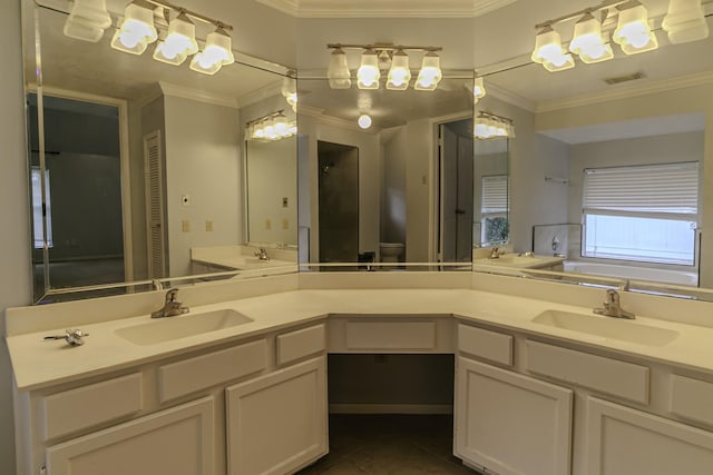 bathroom with tile patterned flooring, vanity, crown molding, and a bathing tub