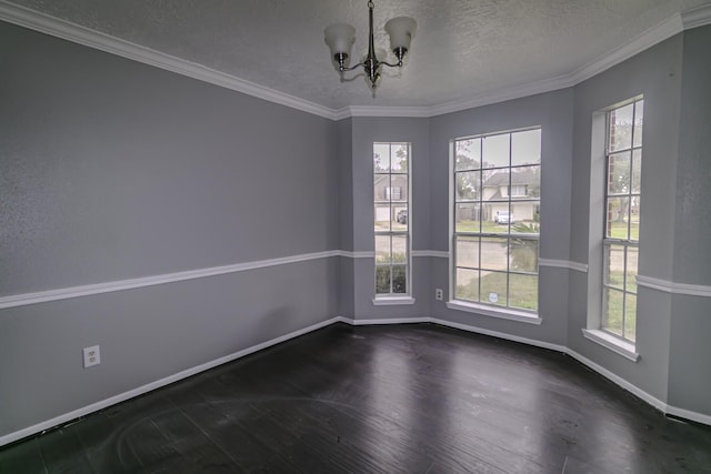 unfurnished room with a notable chandelier, ornamental molding, a textured ceiling, and a wealth of natural light