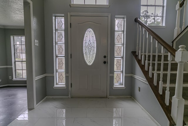 foyer with a healthy amount of sunlight and a textured ceiling