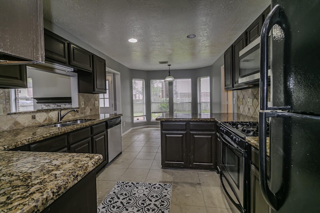 kitchen with black appliances, sink, hanging light fixtures, decorative backsplash, and a textured ceiling