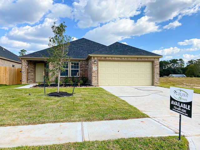 ranch-style home with a garage and a front lawn