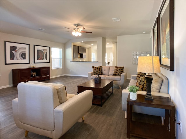 living room featuring ceiling fan, dark wood-type flooring, and vaulted ceiling