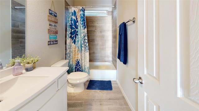 full bathroom featuring shower / bath combo with shower curtain, vanity, and toilet