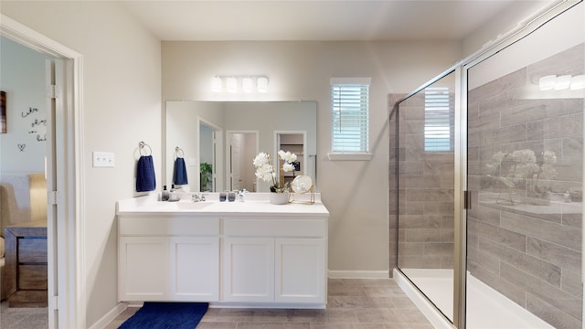 bathroom with tile patterned flooring, vanity, and walk in shower