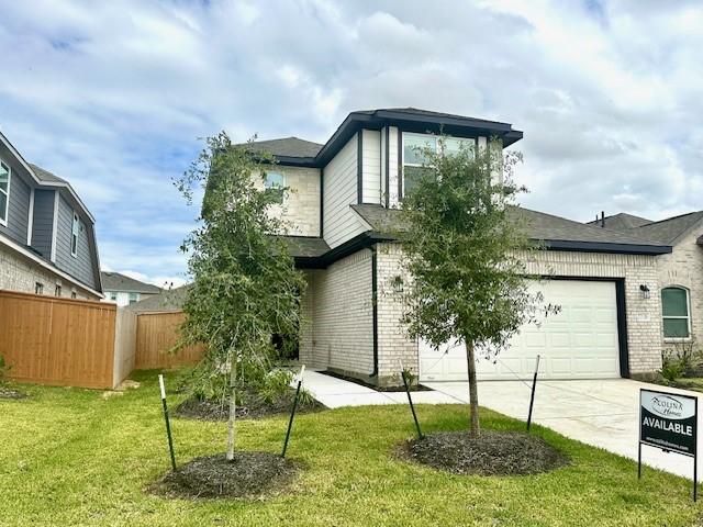 view of front of property with a garage and a front lawn