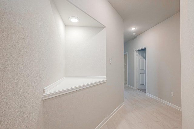 corridor with light hardwood / wood-style flooring