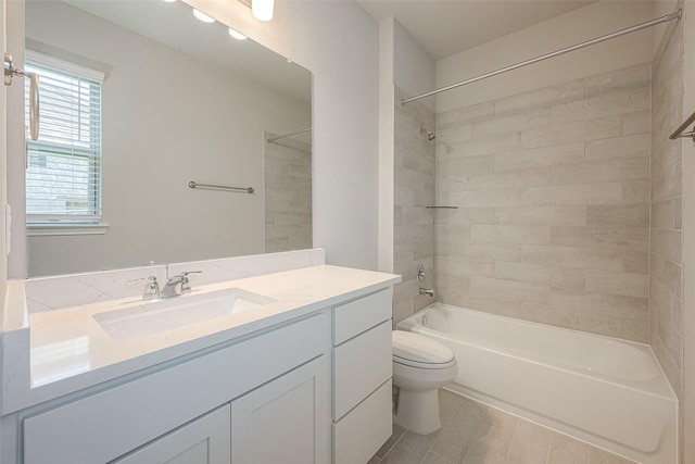 full bathroom with vanity, toilet, and tiled shower / bath