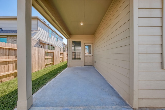 view of exterior entry with a patio