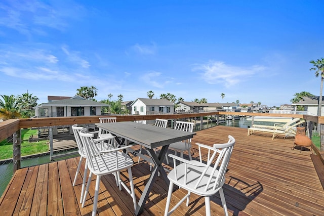 wooden terrace with a water view and a boat dock