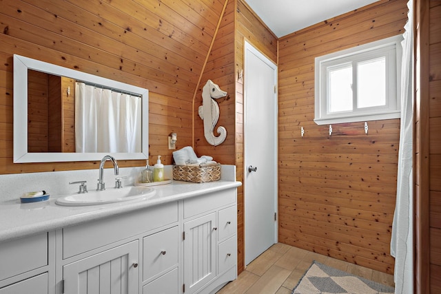 bathroom with vanity and wood walls