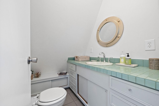 bathroom featuring tile patterned floors, vanity, and toilet