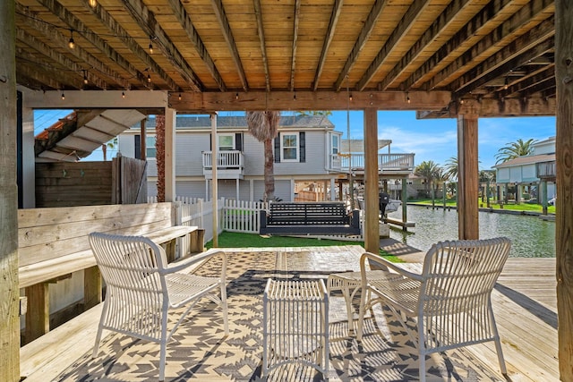 view of patio / terrace featuring a water view and a dock