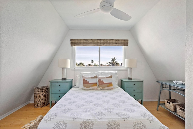 bedroom with wood-type flooring, ceiling fan, and lofted ceiling