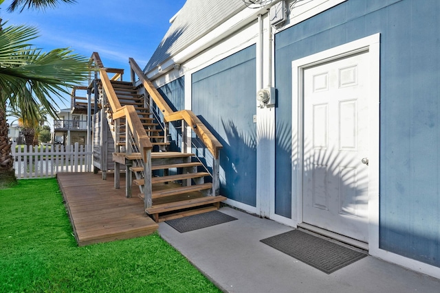 view of exterior entry with a wooden deck