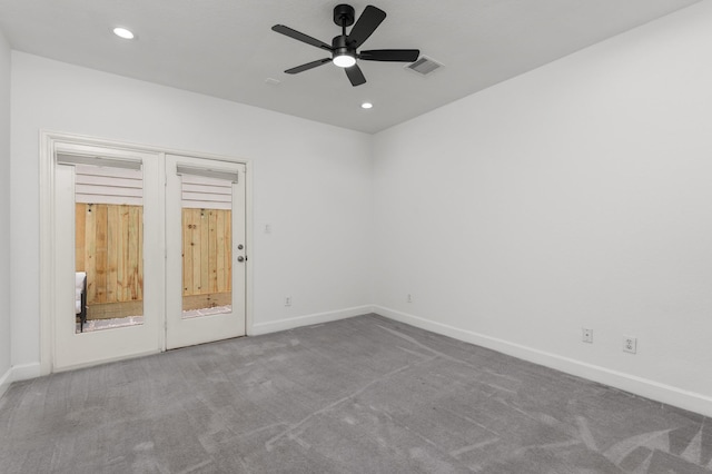 carpeted spare room featuring ceiling fan