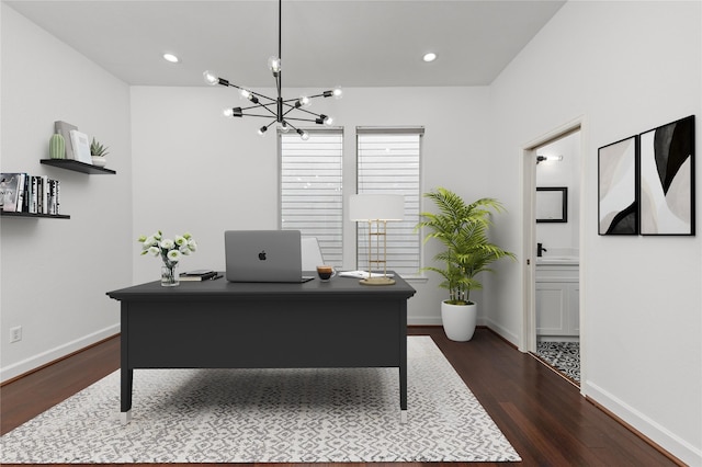 office with dark hardwood / wood-style flooring and an inviting chandelier