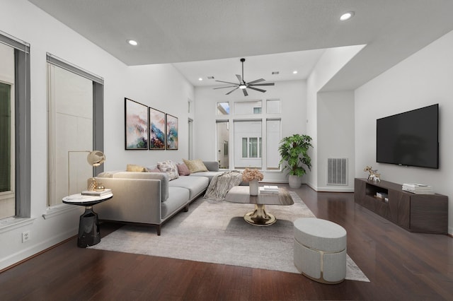 living room featuring dark hardwood / wood-style floors and ceiling fan