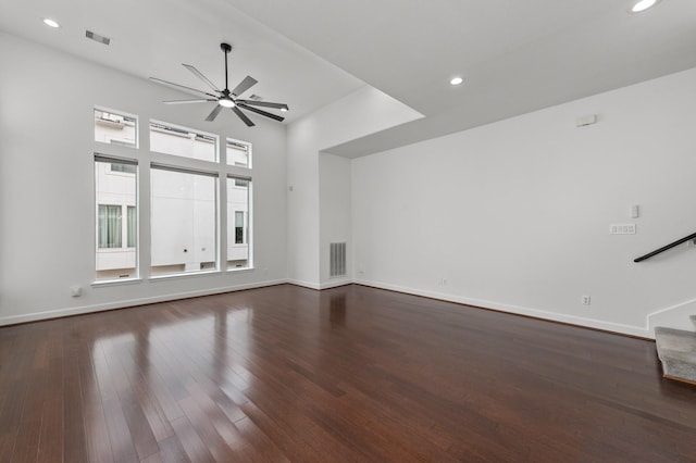 unfurnished living room with ceiling fan and dark wood-type flooring