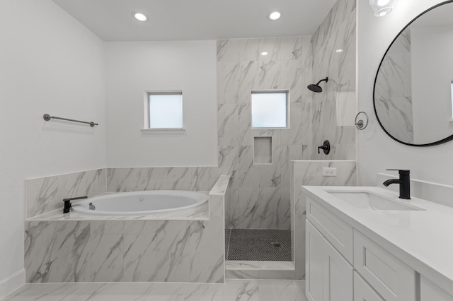 bathroom featuring vanity and shower with separate bathtub