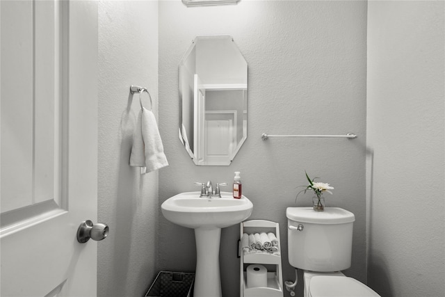 bathroom featuring toilet and sink