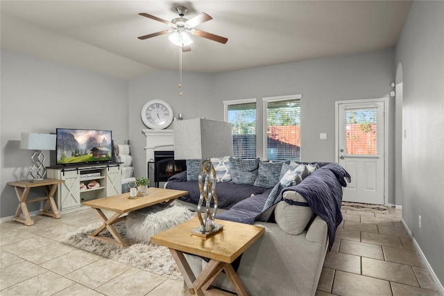 living room with ceiling fan, light tile patterned flooring, and vaulted ceiling