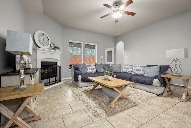 living room featuring ceiling fan and vaulted ceiling