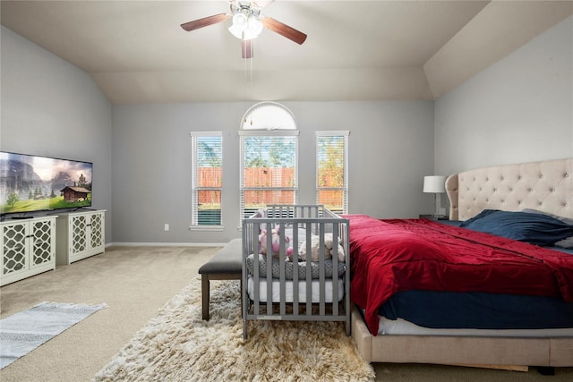 carpeted bedroom featuring ceiling fan and vaulted ceiling