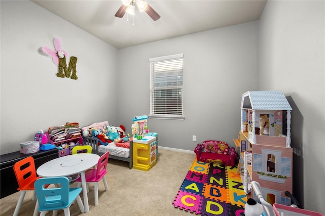 rec room with ceiling fan and light carpet