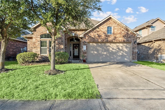 front facade featuring a front lawn and a garage