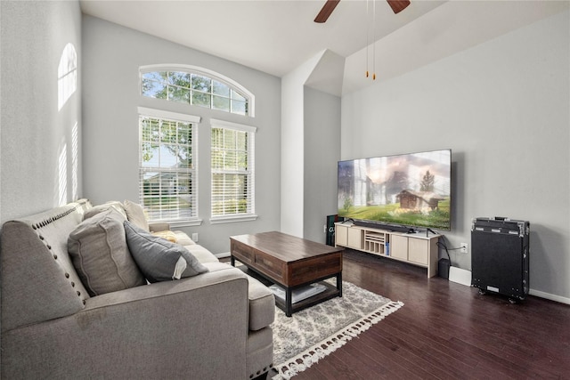 living room featuring ceiling fan and dark hardwood / wood-style floors