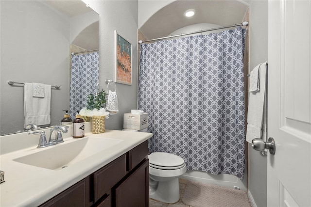 bathroom with vanity, toilet, and walk in shower