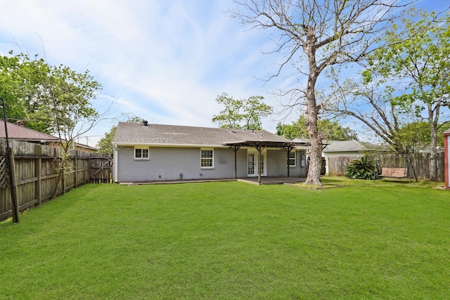 back of house with a lawn and a patio area