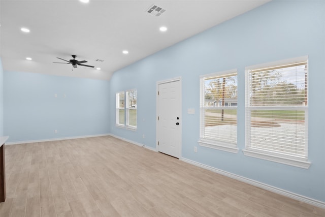 unfurnished room featuring light wood-type flooring, vaulted ceiling, and ceiling fan