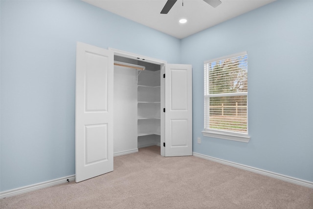 unfurnished bedroom with multiple windows, light carpet, a closet, and ceiling fan